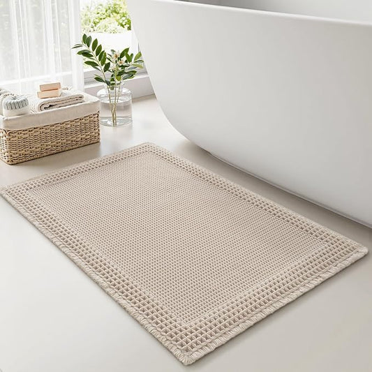 RESARE Waffle Bath Mat for Bathroom, Super Absorbent Bathroom Rugs Non Slip Machine Washable, Ultra Soft Quick Dry Boho Bath Rugs with Tassels for Floor, Upgraded Bordered Design, 24"x36" Pale Beige